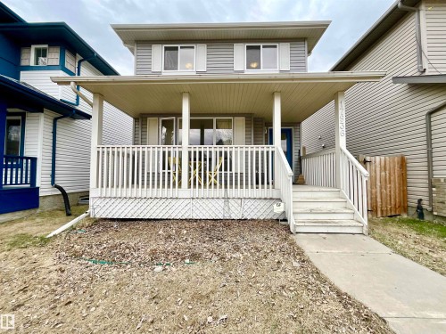 Two-story residence featuring light gray siding and white window shutters - 17936 85 Street, Edmonton, AB - Outdoor With Deck Patio Veranda