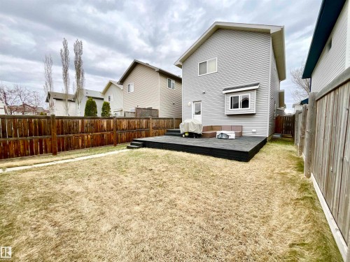 Private backyard featuring a dark-stained deck and a brown privacy fence - 17936 85 Street, Edmonton, AB - Outdoor