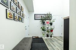 Foyer featuring high ceilings, wood-finish flooring, and white paneled doors - 