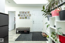 Entryway featuring light wood-finish flooring and a white paneled door - 