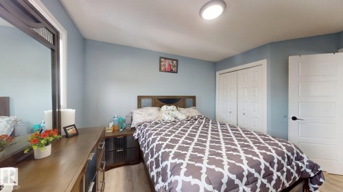 This room features light blue walls, light-colored flooring, and a ceiling light fixture - 3613 11 Street, Edmonton, AB - Indoor Photo Showing Bedroom