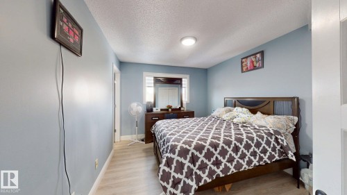 The room features light blue walls, a white ceiling, and light-colored flooring - 3613 11 Street, Edmonton, AB - Indoor Photo Showing Bedroom