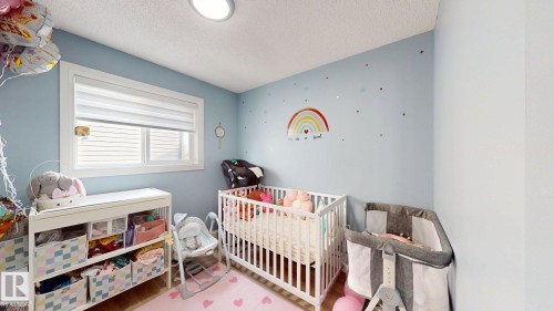 This room features light blue walls, a white ceiling, and hardwood flooring - 3613 11 Street, Edmonton, AB - Indoor Photo Showing Other Room