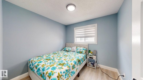 This room features light blue walls, a window with blinds, and light-colored flooring - 3613 11 Street, Edmonton, AB - Indoor Photo Showing Bedroom