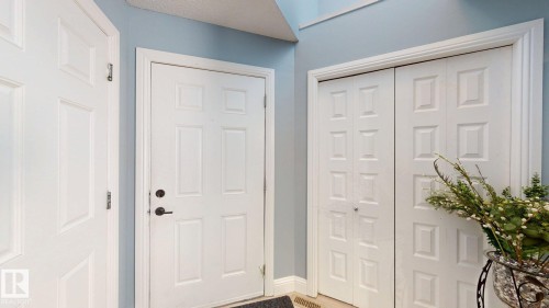 Entryway featuring light blue walls, white trim, and white doors - 3613 11 Street, Edmonton, AB - Indoor Photo Showing Other Room
