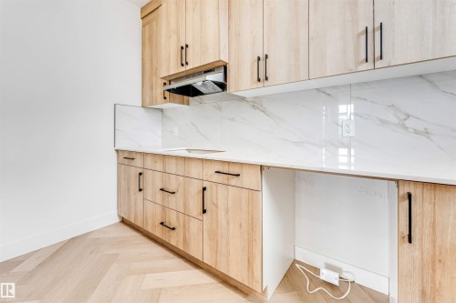 Kitchenette with light wood-finish cabinetry, black hardware, white countertop, and matching backsplash - 4006 35 St, Beaumont, AB - Indoor