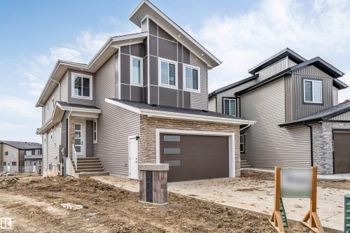 Modern exterior showcasing multi-tone siding and stone veneer accents - 4006 35 St, Beaumont, AB - Outdoor