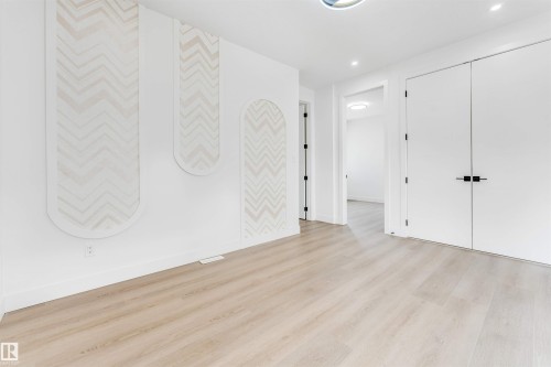 Light wood-finish flooring extending throughout the space - 4006 35 St, Beaumont, AB - Indoor Photo Showing Other Room