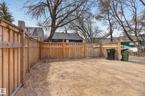 Enclosed yard area featuring natural wood privacy fencing - 8722 112 Avenue, Edmonton, AB - Outdoor