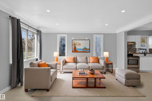 Open-concept living area featuring light wood-finish flooring, recessed lighting, and crisp white trim - 8722 112 Avenue, Edmonton, AB - Indoor Photo Showing Living Room