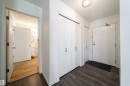 Entryway with dark wood-finish flooring, white walls, and a white entrance door - 302 9138 83 Avenue, Edmonton, AB  - Indoor Photo Showing Other Room 