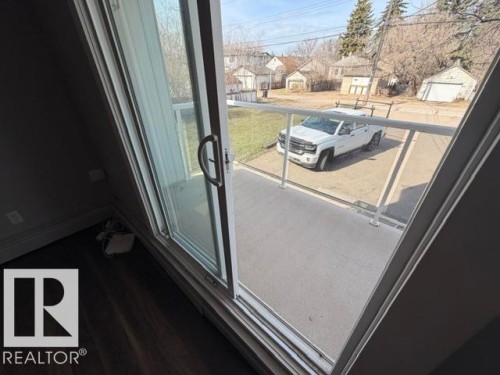 Sliding glass patio door opening to an outdoor balcony - 201 11324 97 Street Nw, Edmonton, AB - Outdoor