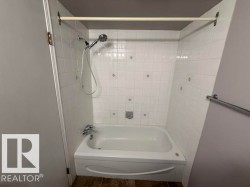 White subway tile shower surround with decorative accent tiles - 
