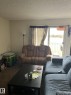 Living area with sliding glass door access to an outdoor balcony - 68 11265 31 Avenue, Edmonton, AB  - Indoor Photo Showing Living Room 