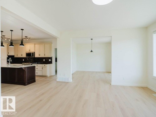 Open-concept kitchen and living area featuring light wood-finish flooring - 15867 11 Avenue, Edmonton, AB - Indoor Photo Showing Kitchen