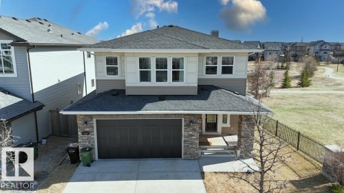 Contemporary two-story residence featuring a dark asphalt shingle roof and a two-tone exterior with light siding and darker horizontal panels - 15867 11 Avenue, Edmonton, AB - Outdoor
