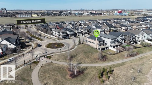 Aerial perspective of a suburban neighborhood featuring numerous residential properties with dark roofs - 15867 11 Avenue, Edmonton, AB - Outdoor With View