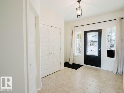 Entryway featuring a black paneled door with glass insert, flanked by sidelight windows - 15867 11 Avenue, Edmonton, AB - Indoor Photo Showing Other Room