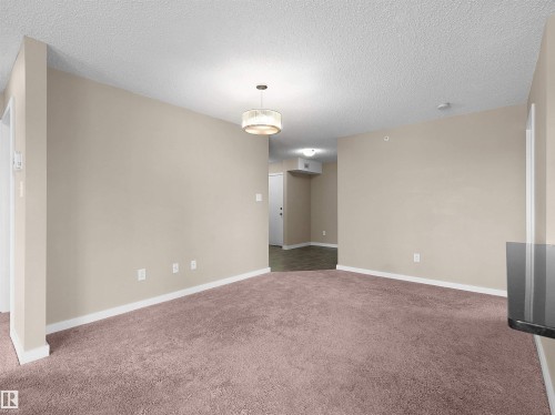 Living area featuring plush carpeting, light neutral wall tones, and white trim - 417 1060 Mcconachie Boulevard, Edmonton, AB - Indoor Photo Showing Other Room