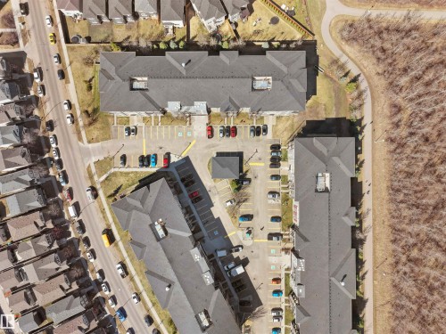 Apartment building with shingle roofing, surface parking, and perimeter landscaping - 417 1060 Mcconachie Boulevard, Edmonton, AB - 