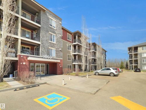 Multi-story residential building featuring a stone and siding exterior - 417 1060 Mcconachie Boulevard, Edmonton, AB - Outdoor With Balcony With Facade
