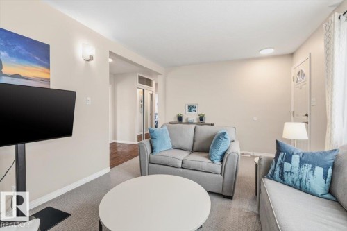 Inviting living space featuring light neutral wall tones, recessed lighting, and soft carpet flooring - 13107 133 Street, Edmonton, AB - Indoor Photo Showing Living Room