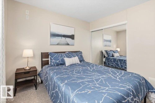 Beige wall finishes with white baseboards - 13107 133 Street, Edmonton, AB - Indoor Photo Showing Bedroom