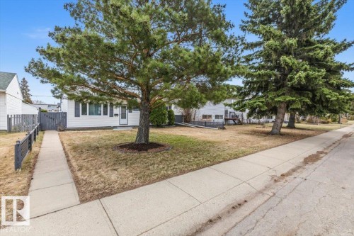 White siding exterior with black window shutters and a white front door - 13107 133 Street, Edmonton, AB - Outdoor