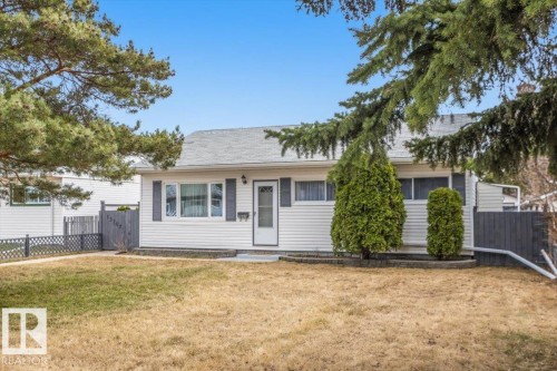 White siding exterior with dark gray shutters and a prominent front entry door - 13107 133 Street, Edmonton, AB - Outdoor