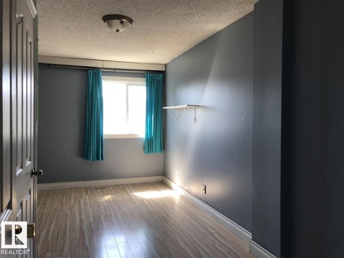 Interior room featuring wood-finish flooring and a single window - 11507 141 Avenue, Edmonton, AB - Indoor Photo Showing Other Room