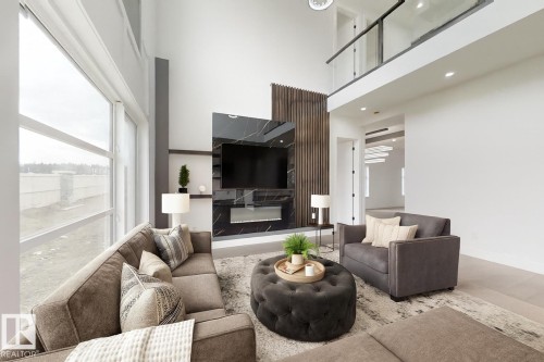 Two-story living area featuring a prominent fireplace wall with black-veined paneling, a built-in electric fireplace, and dark wood slat accents - 1707 18 Street Nw, Edmonton, AB - Indoor Photo Showing Living Room