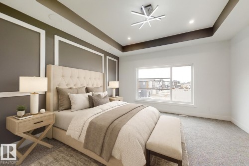 Spacious bedroom featuring decorative wall molding, a tray ceiling with recessed lighting and a modern ceiling fixture, a large window with white trim, and gray carpeting - 1707 18 Street Nw, Edmonton, AB - Indoor Photo Showing Bedroom