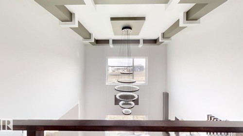 Two-story entryway featuring a multi-tiered chandelier and a window - 1707 18 Street Nw, Edmonton, AB - Indoor Photo Showing Kitchen