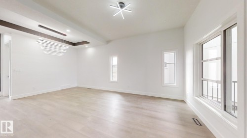 Spacious room featuring vaulted ceilings and light wood-finish flooring - 1707 18 Street Nw, Edmonton, AB - Indoor Photo Showing Other Room