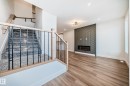 100 Elliott Wynd, Fort Saskatchewan, AB  - Indoor Photo Showing Other Room With Fireplace 