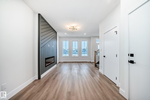 100 Elliott Wynd, Fort Saskatchewan, AB - Indoor Photo Showing Other Room With Fireplace