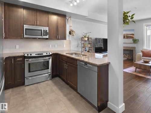 #13 11518 76 Av Nw, Edmonton, AB - Indoor Photo Showing Kitchen With Stainless Steel Kitchen With Double Sink