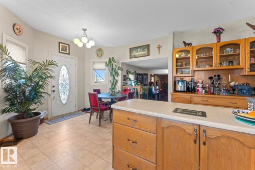 Functional kitchen island featuring light-toned countertop - 1414 7 Avenue, Cold Lake, AB - Indoor Photo Showing Kitchen