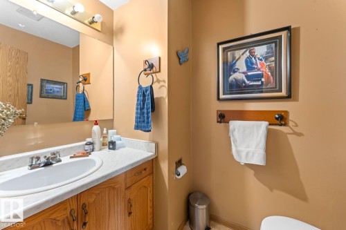 Bathroom vanity featuring a white sink, chrome faucet, and a light-toned countertop - 1414 7 Avenue, Cold Lake, AB - Indoor Photo Showing Bathroom