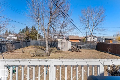 Expansive backyard featuring mature trees, a storage shed, and a privacy fence - 1414 7 Avenue, Cold Lake, AB - Outdoor