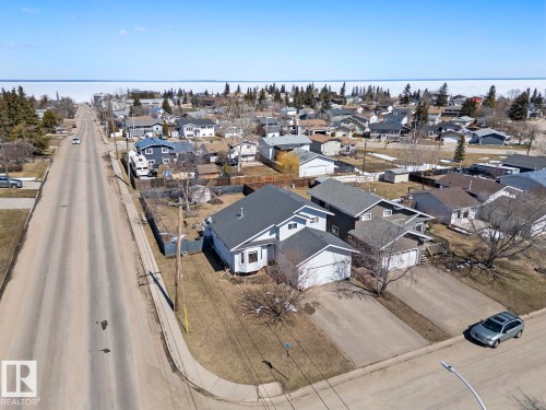 Aerial perspective of a neighborhood with a large body of water in the background - 1414 7 Avenue, Cold Lake, AB - Outdoor With Body Of Water With View