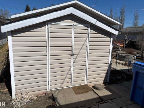 Gable-roof storage shed featuring horizontal beige siding and white trim - 4824 49 Avenue, Sangudo, AB - Outdoor With Exterior
