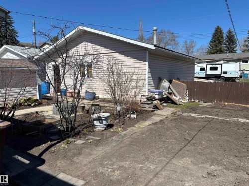 Rear exterior of the property featuring light-colored siding - 4824 49 Avenue, Sangudo, AB - Outdoor