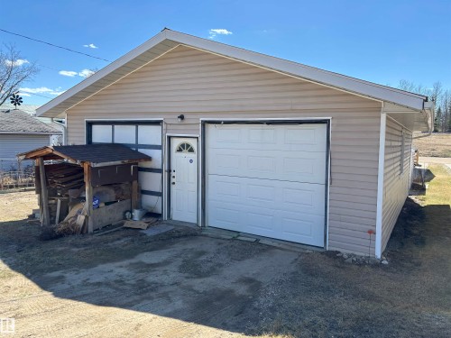 Two-bay garage with tan horizontal siding - 4824 49 Avenue, Sangudo, AB - Outdoor With Exterior