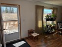 Entryway featuring wood-finish flooring, a white storm door, and natural light - 4824 49 Avenue, Sangudo, AB  - Indoor 
