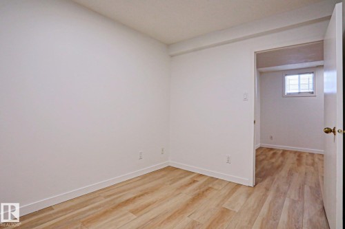Room featuring light wood-finish flooring, white walls, and white trim - 9611 81 Avenue, Edmonton, AB - Indoor Photo Showing Other Room