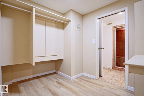 Dedicated storage area featuring built-in cabinetry and hanging rods - 9611 81 Avenue, Edmonton, AB - Indoor Photo Showing Other Room