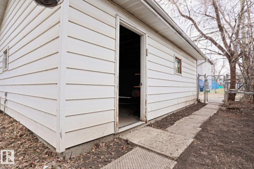 Detached outbuilding with white horizontal siding and a window - 9611 81 Avenue, Edmonton, AB - Outdoor With Exterior