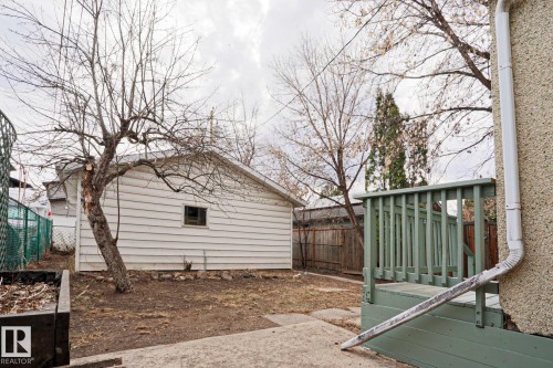 Detached garage with horizontal siding, a single window, and a gabled roof - 9611 81 Avenue, Edmonton, AB - Outdoor