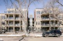 This property features a multi-story building with a facade of light-colored brick and dark-framed windows - 211 10808 71 Avenue, Edmonton, AB  - Outdoor With Facade 